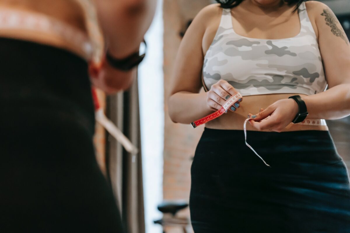 Weight loss woman in mirror with measuring tape stock image weight loss